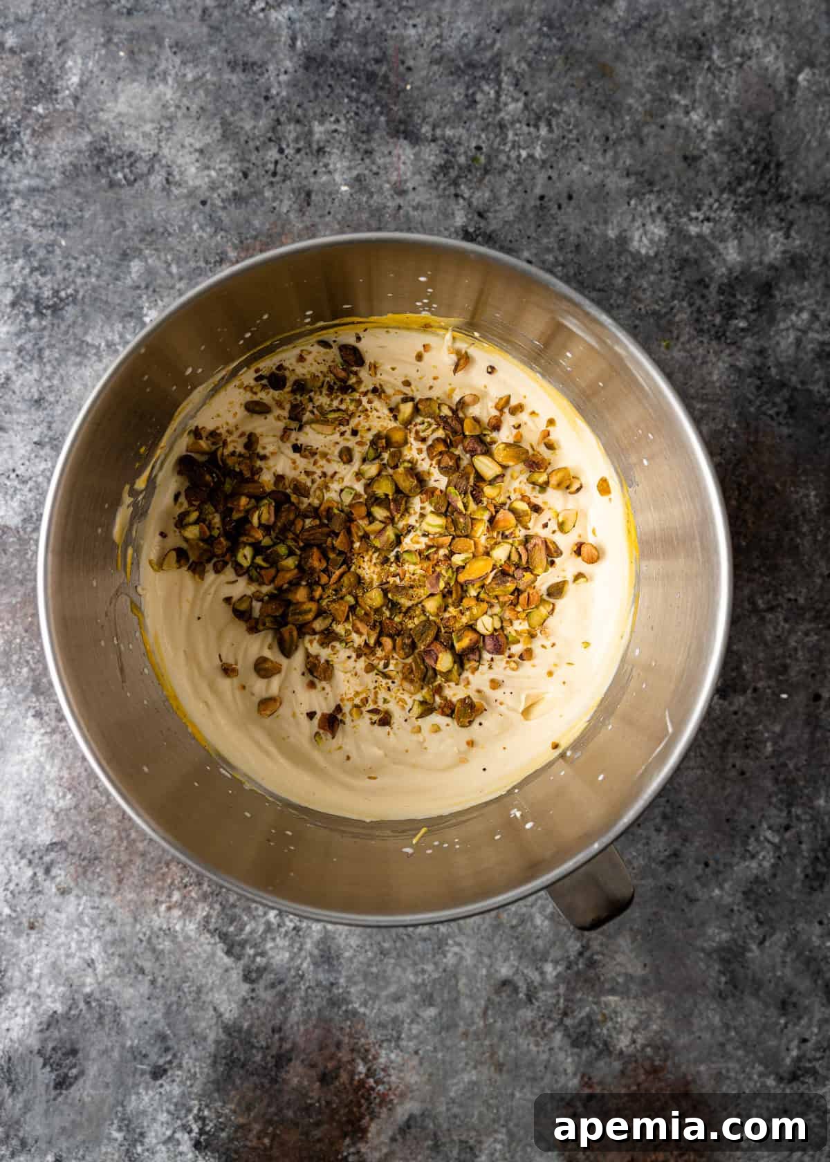Process shot: Crushed pistachios are gently folded into the saffron-infused ice cream mixture for added texture and flavor.