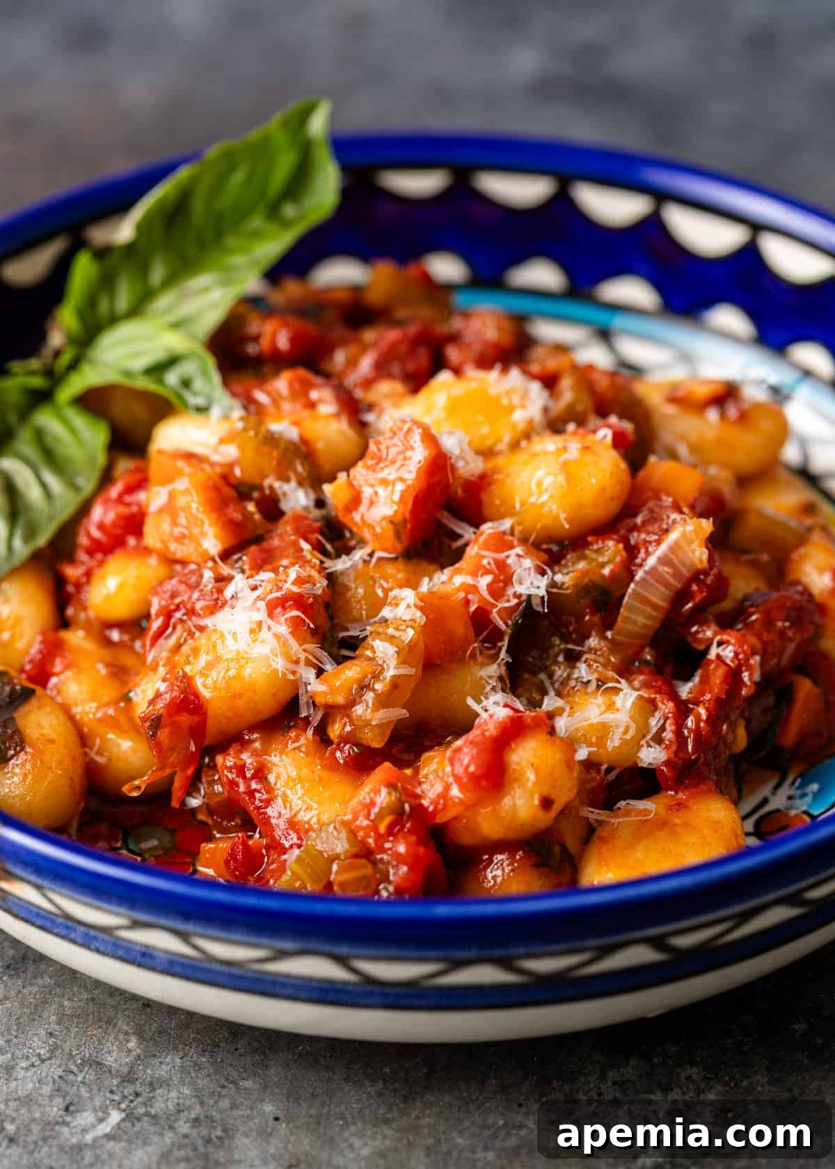closeup side view: ready to eat pasta sugo finto served in a shallow bowl