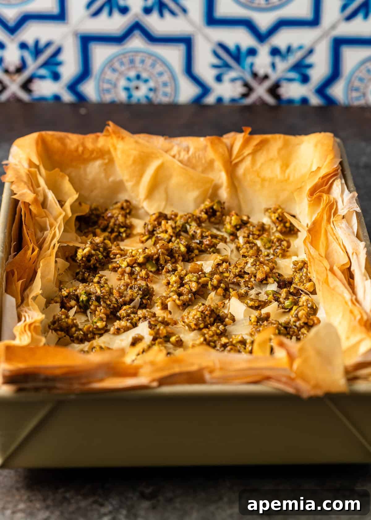 overhead process shot: baked baklava cheesecake in pan