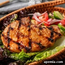 Delicious Vietnamese Pork Chops (Sườn Nướng) on a plate with fresh garnish.
