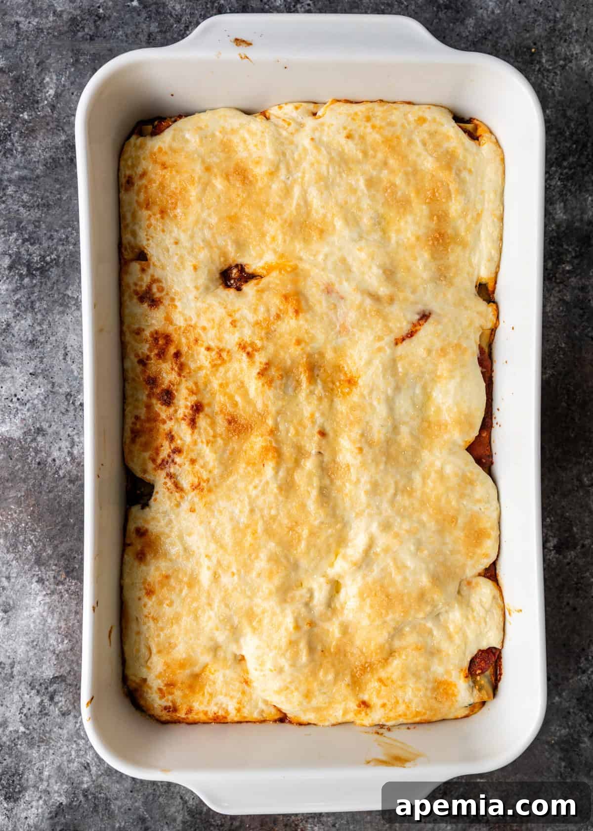 overhead: spinach cannelloni in white baking dish on counter