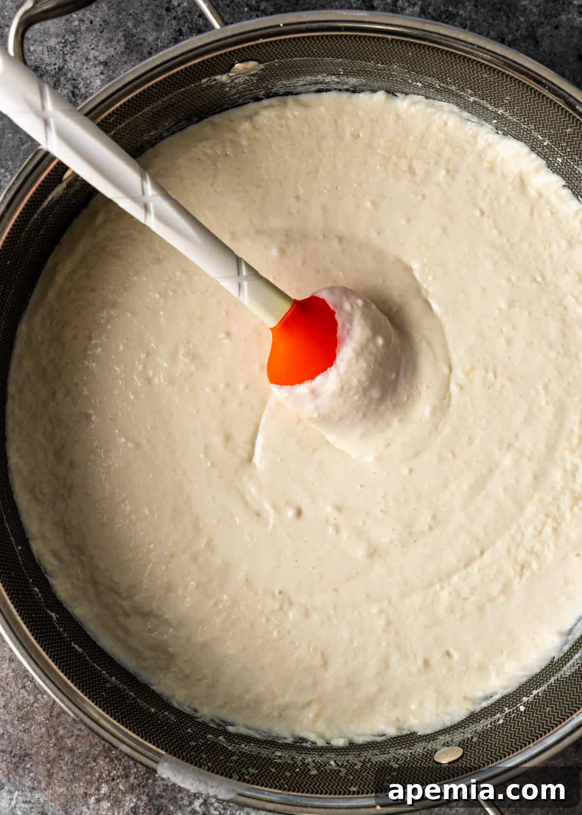 overhead process shot: sauce in large pot with spatula