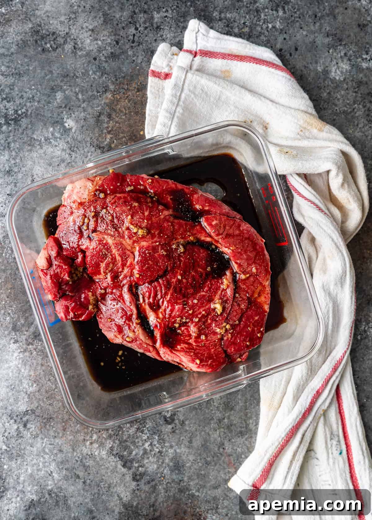 overhead process shot: boneless chuck pot roast marinating in balsamic vinegar and olive oil