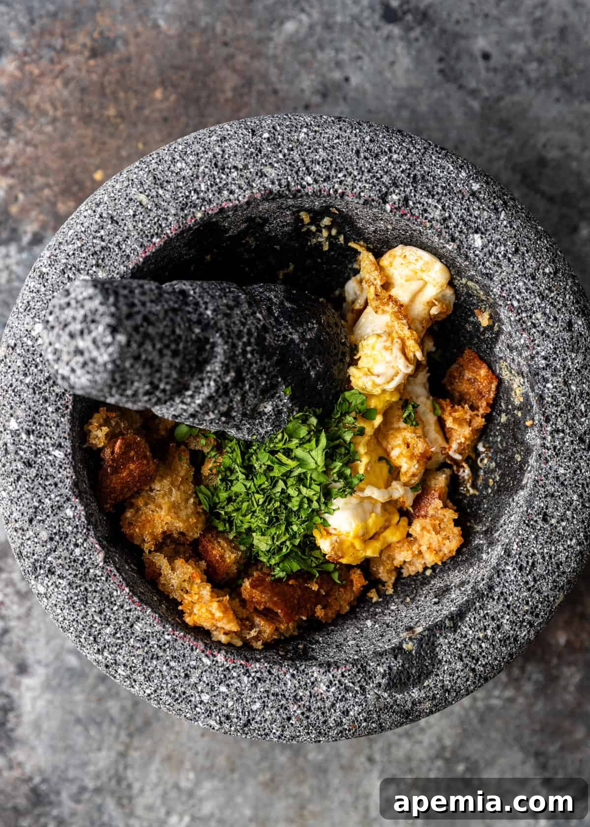 closeup overhead process shot: fried egg and parsley in mortar