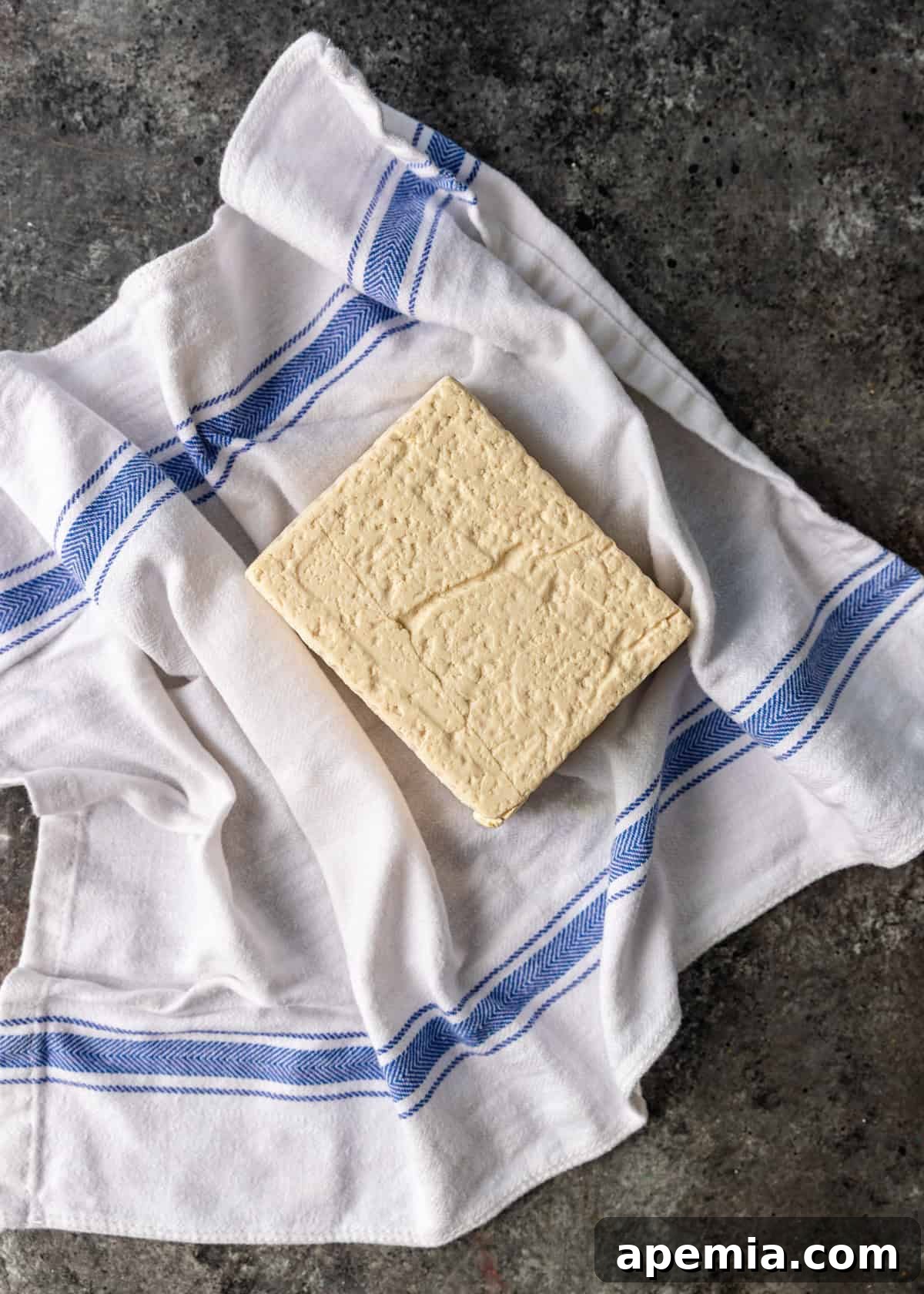 overhead process shot: tofu sitting on absorbent towel