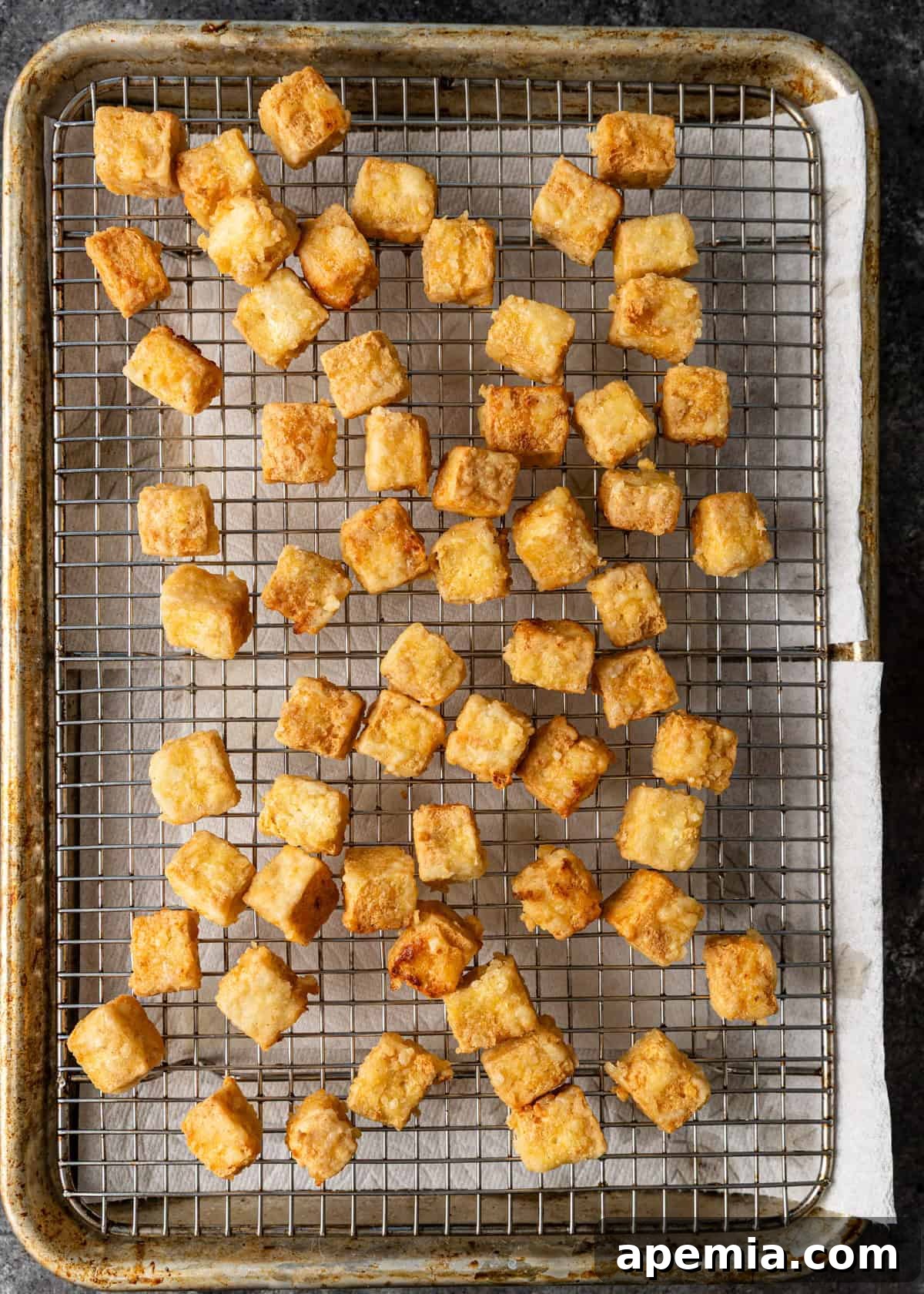 overhead process shot: easy tofu recipe on baking sheet on top of cooling wrack