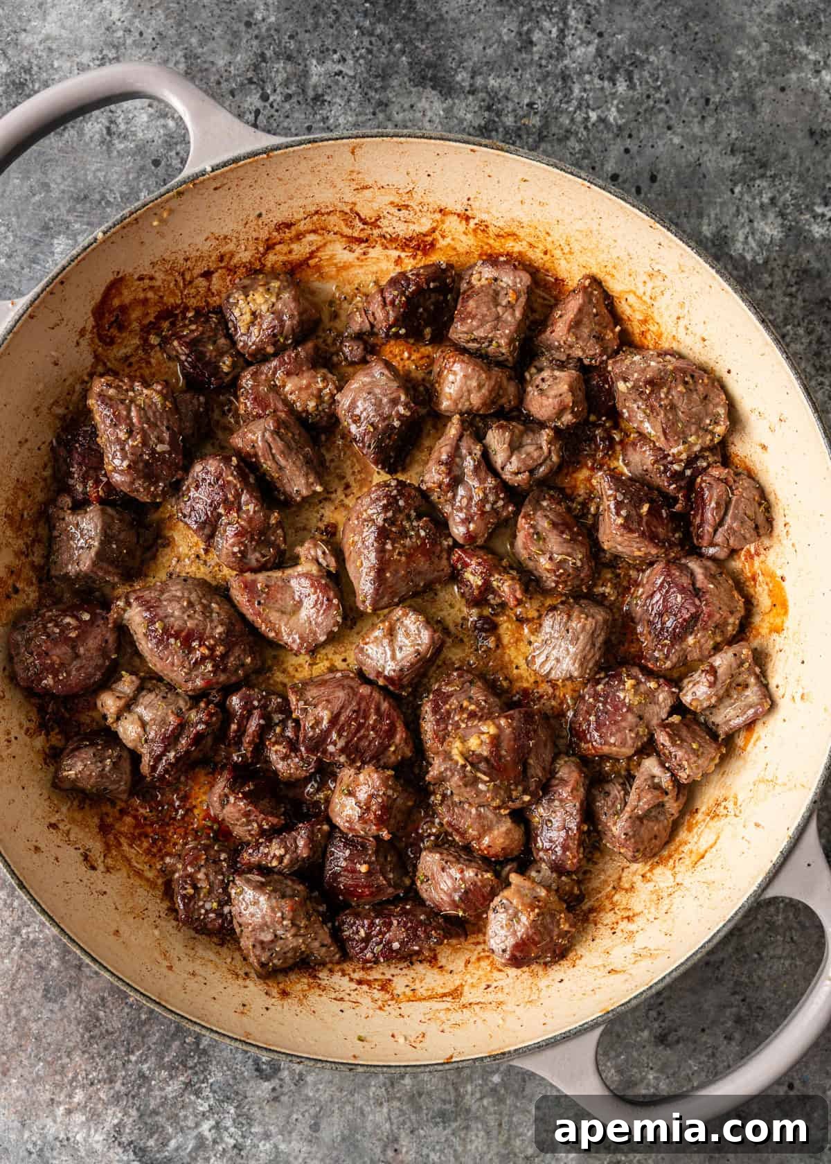 overhead process shot: lamb cubes in skillet