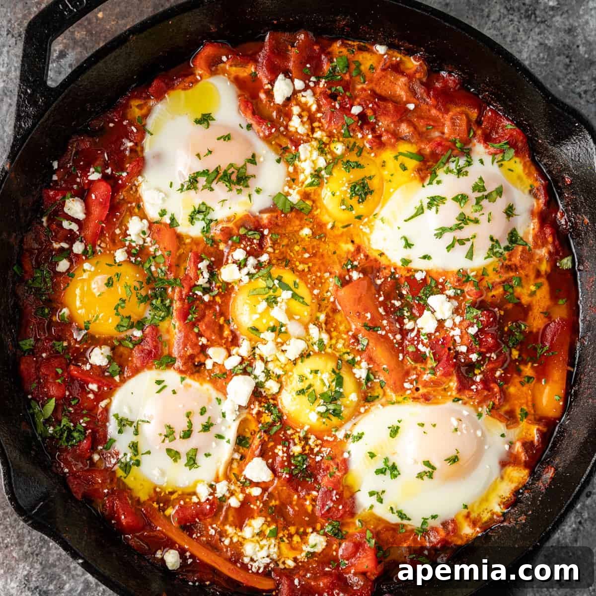 skillet of poached eggs in spicy tomato sauce