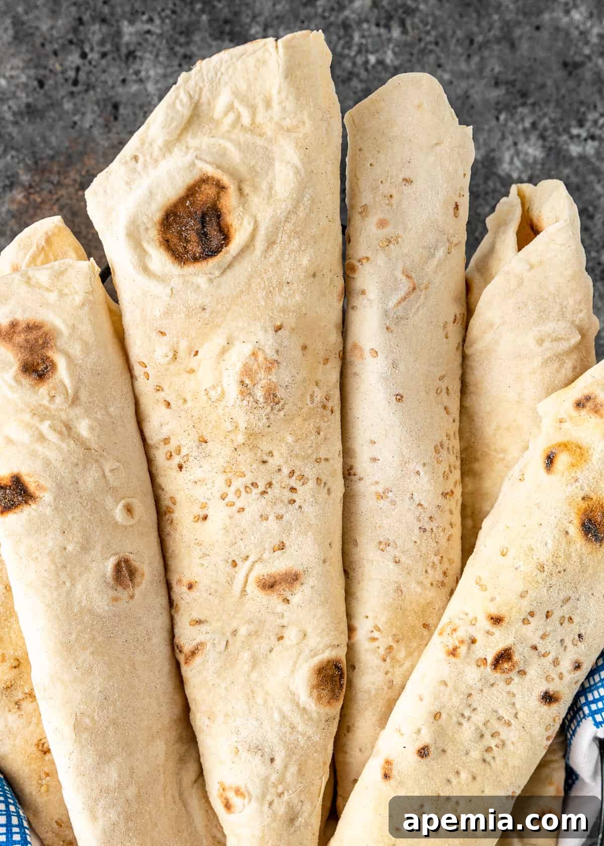Overhead closeup of Armenian flatbread showcasing its beautiful golden blisters and soft texture.