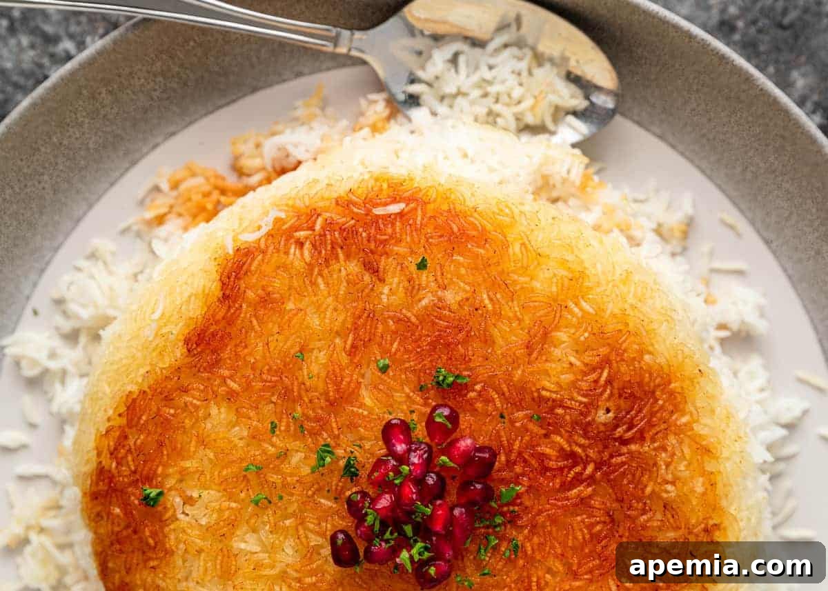 plated Persian crispy rice and a serving spoon laying next to it