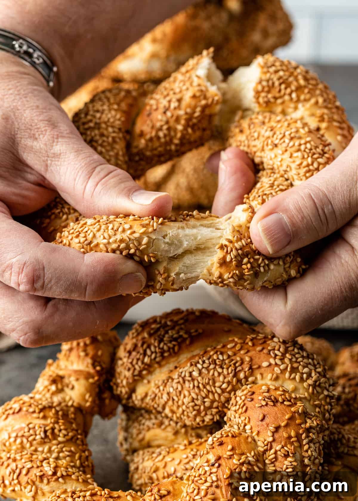 Sesame Bread Rings being pulled apart