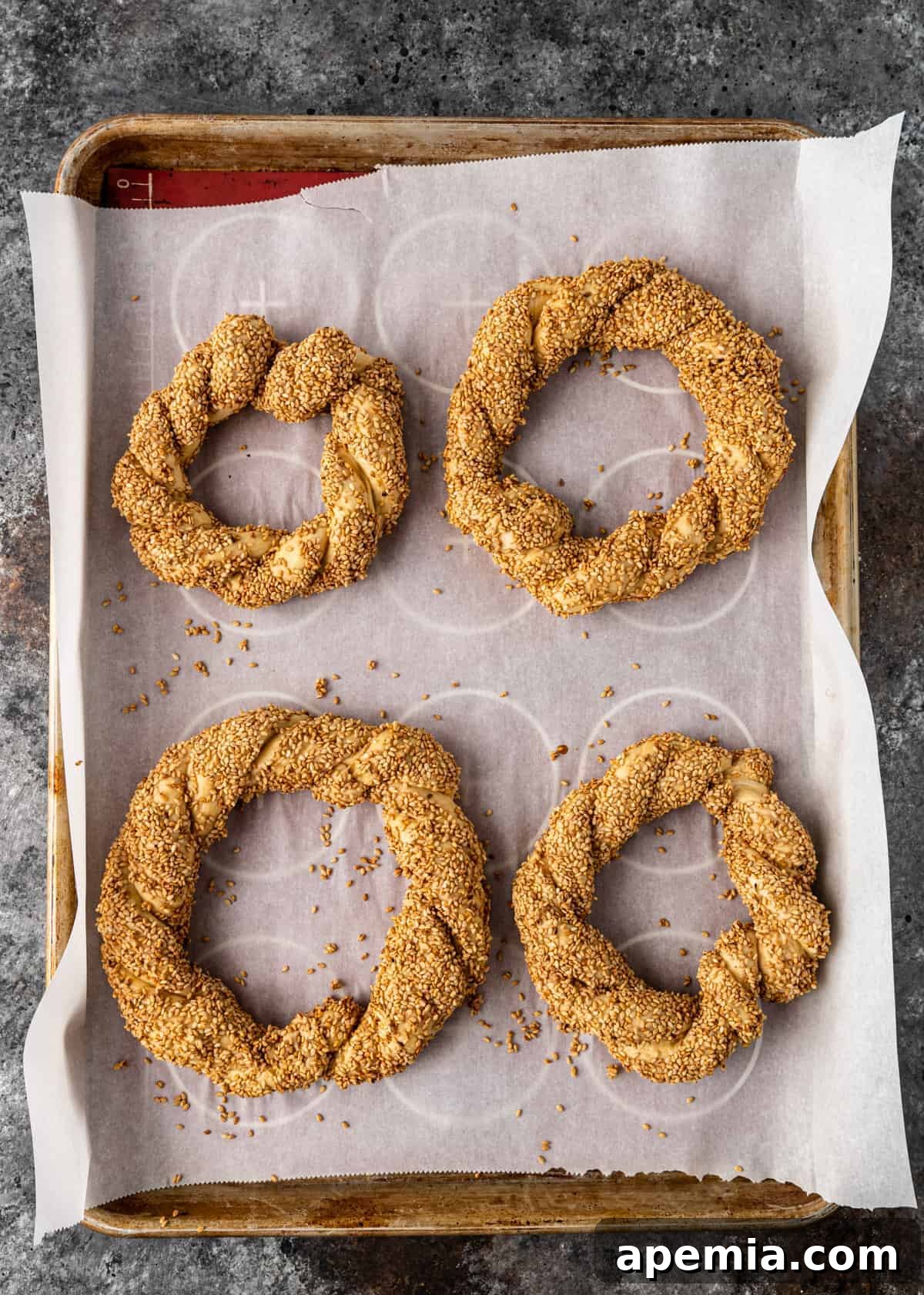 4 coated simit rings on a pan
