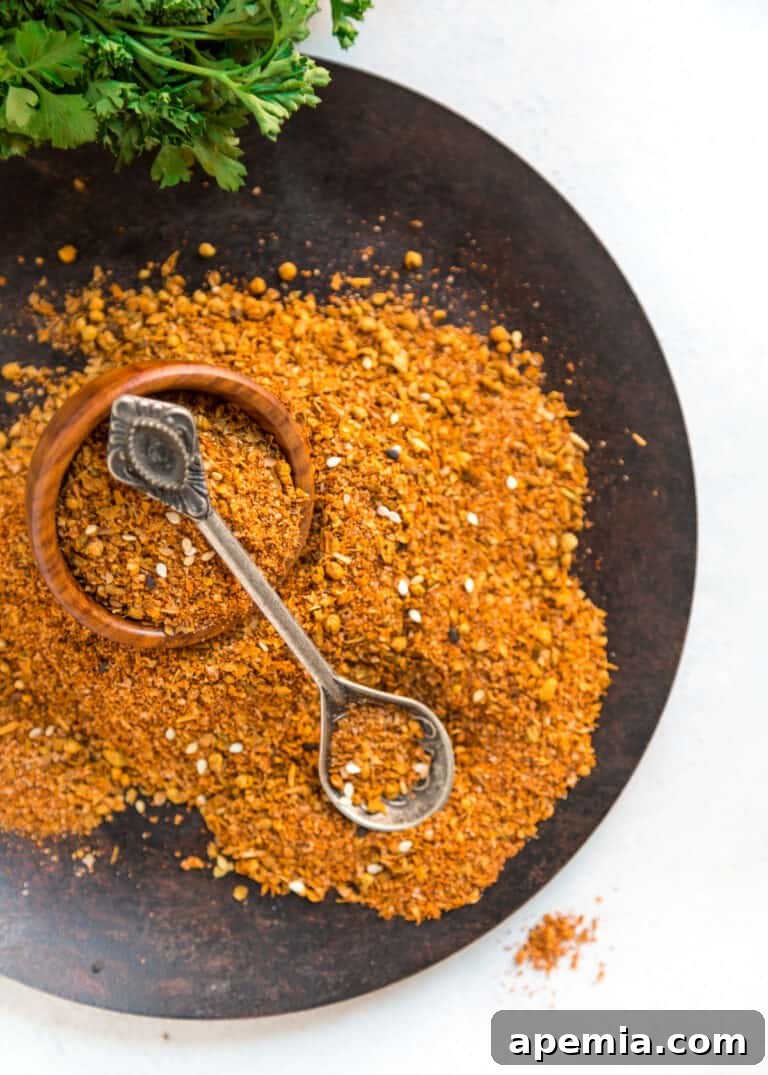 overhead image of spices in a dish with a spoon