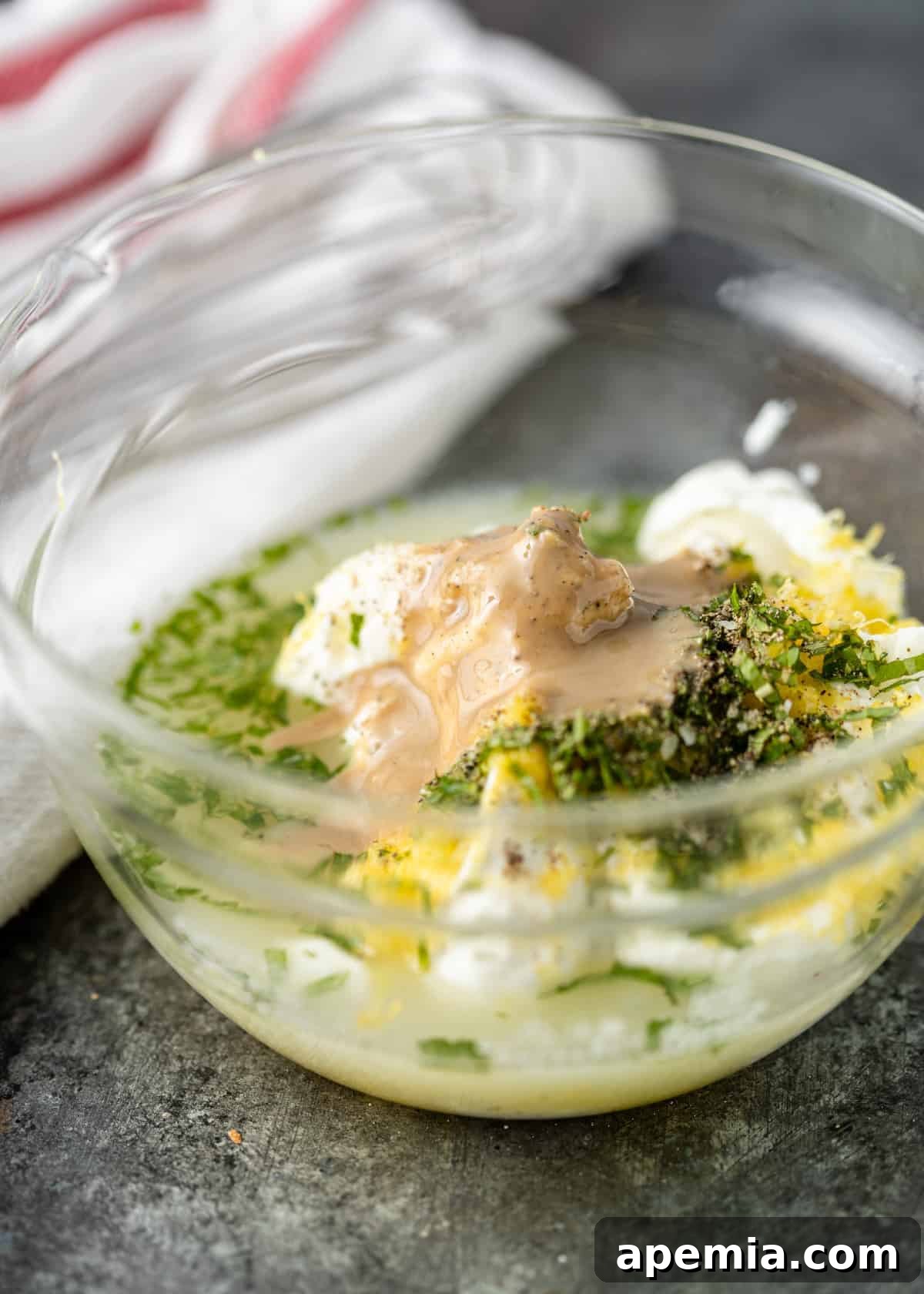 ingredients in a bowl to make tahini yogurt sauce