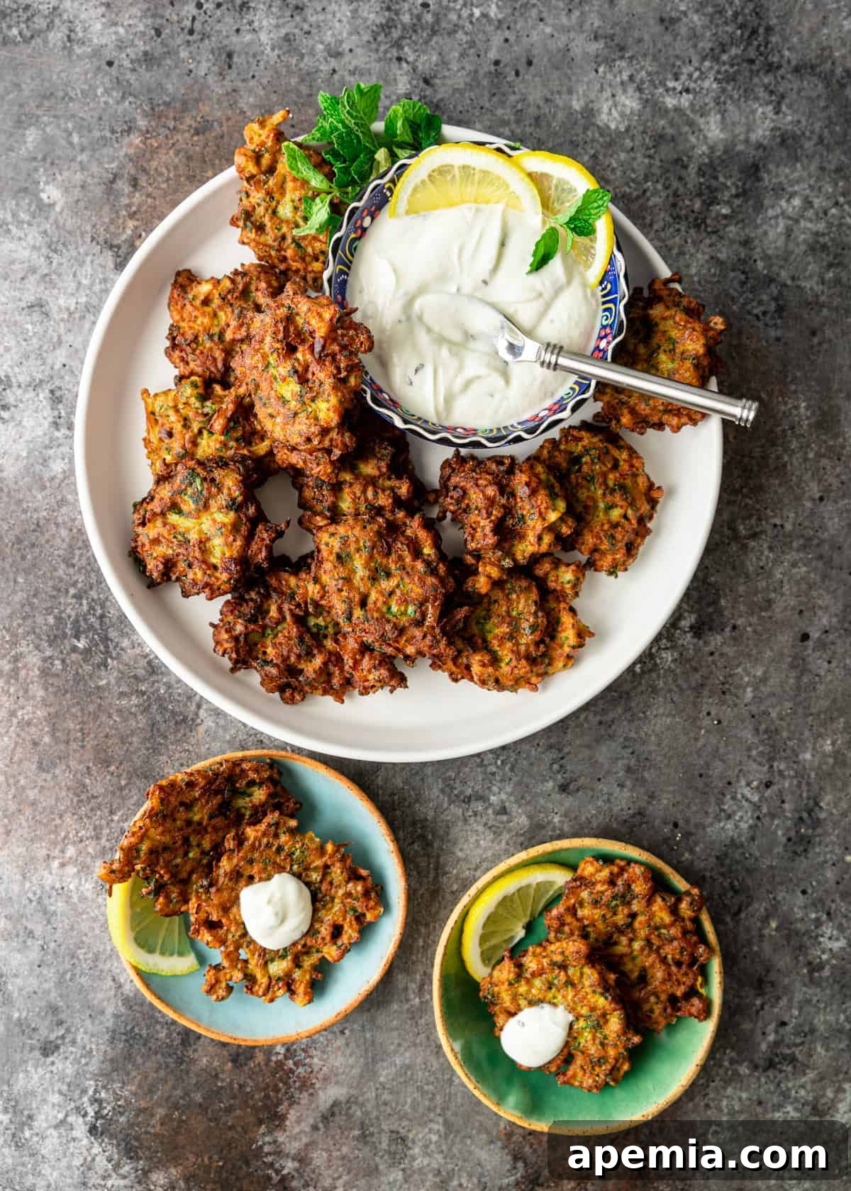 Lemon-Kissed Cauliflower Crisps 4 overhead: round white platter and two serving plates with middle eastern side dishes