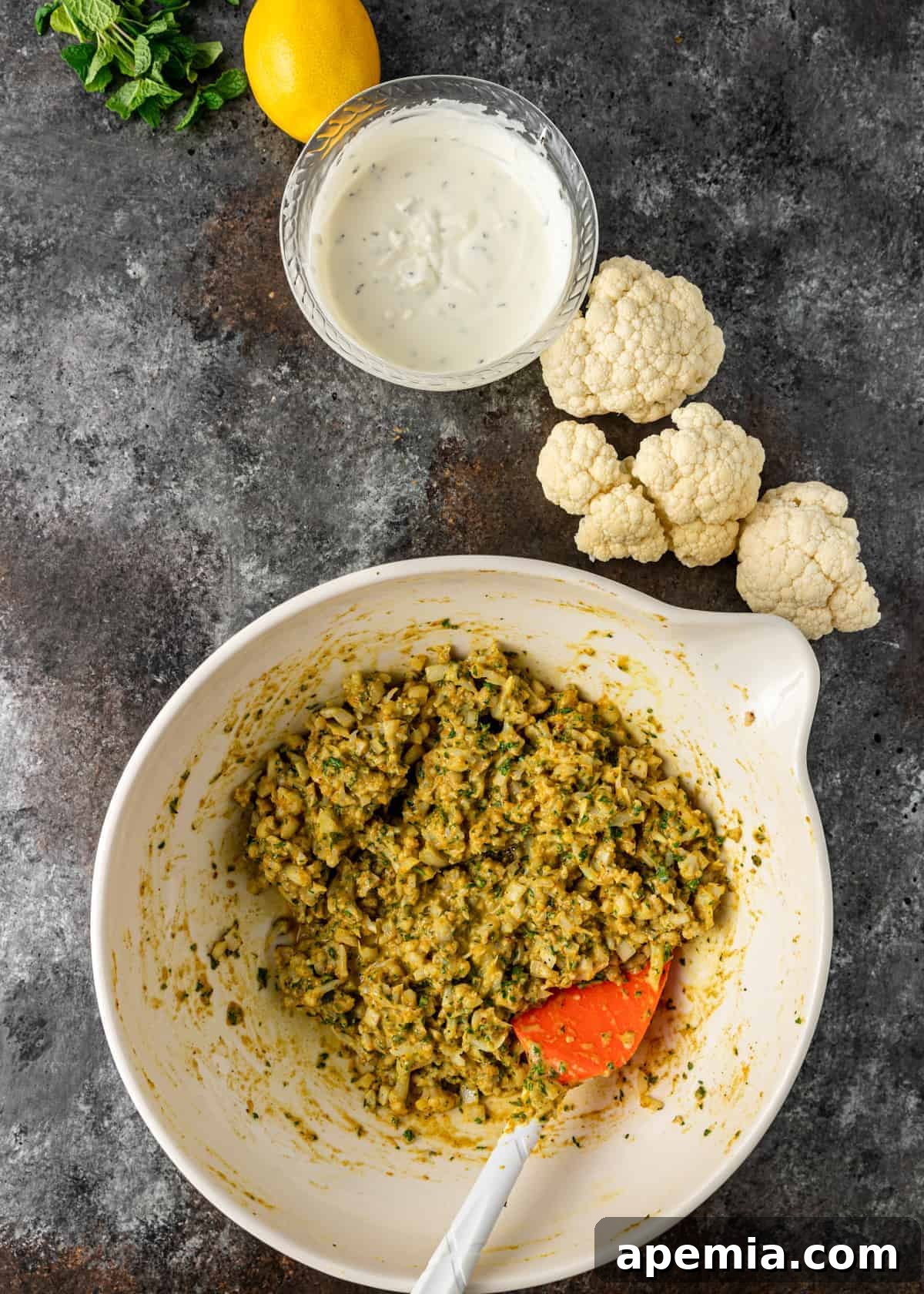Lemon-Kissed Cauliflower Crisps 5 batter in a bowl for cauliflower fritters