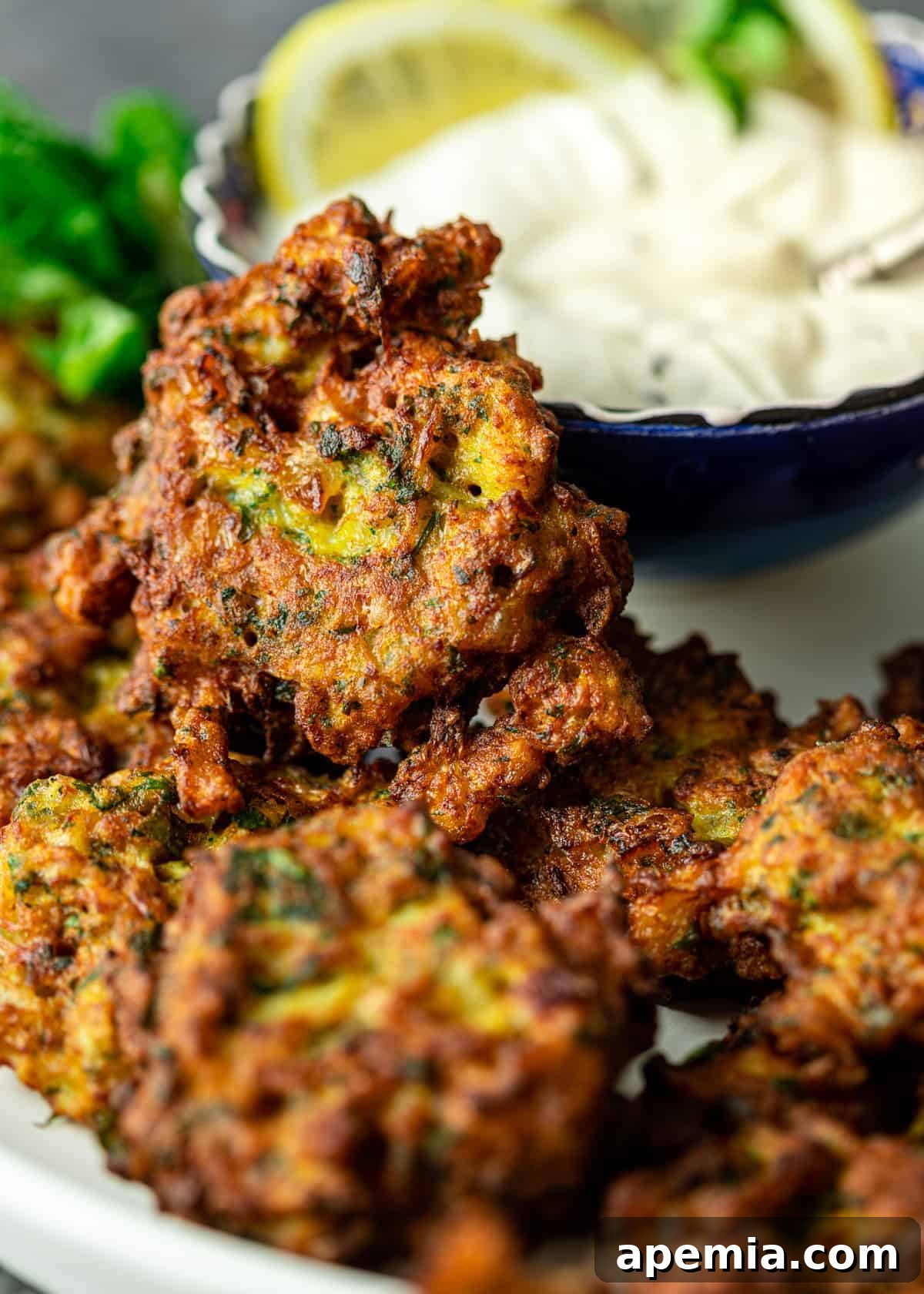 Lemon-Kissed Cauliflower Crisps 7 stack of cauliflower fritters on a serving plate