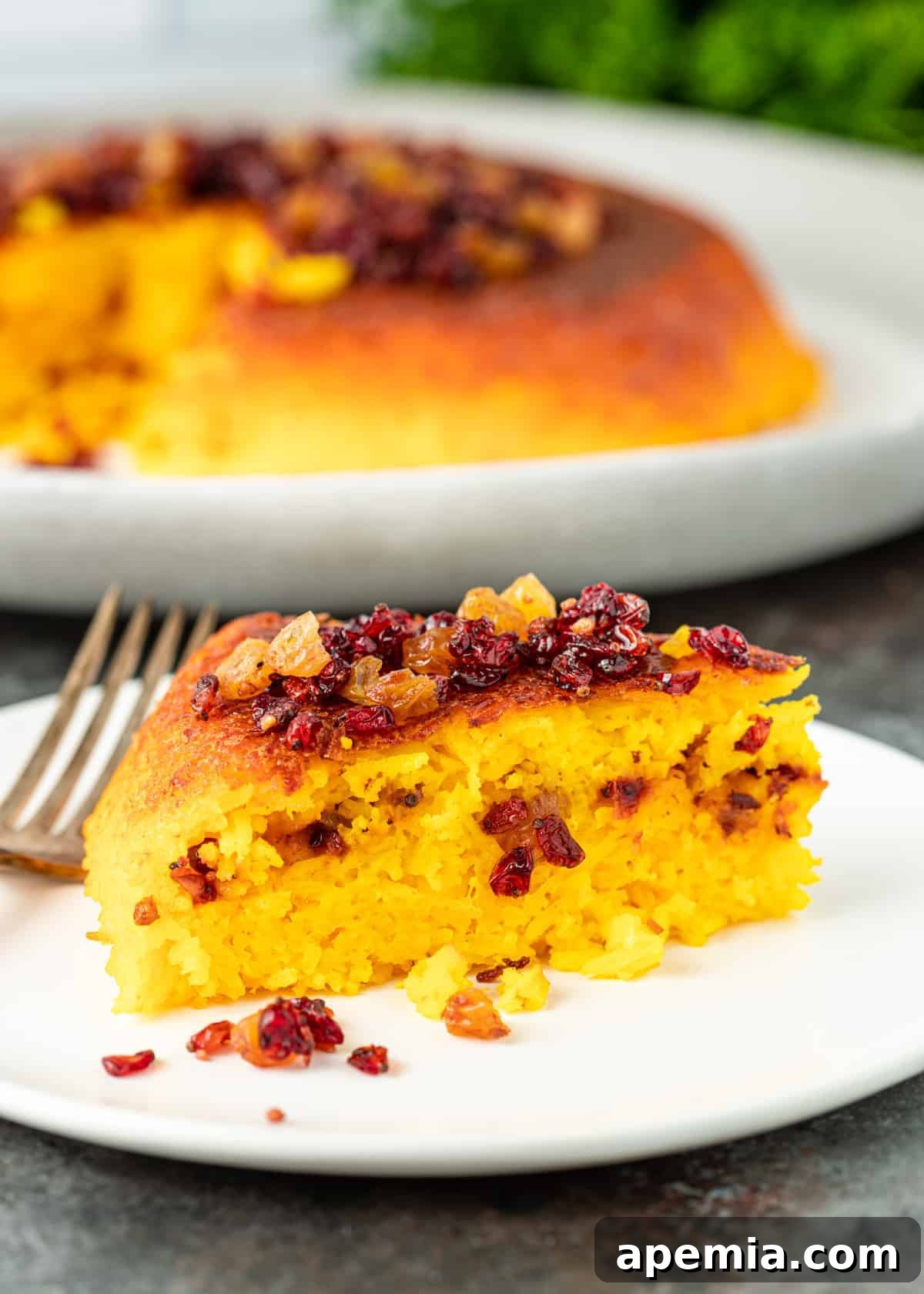 side view: a slice of my tachin recipe showing layer of barberries inside