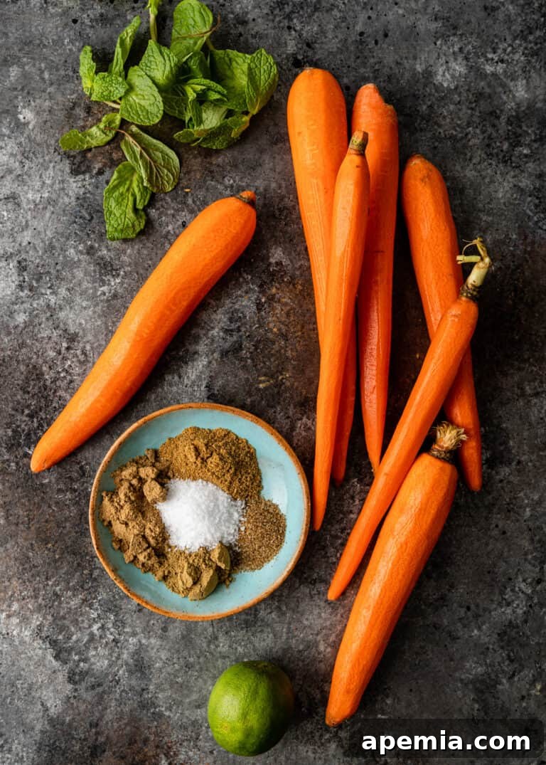 Overhead shot showing a pile of fresh, vibrant carrots, perfectly prepared for roasting in my Moroccan recipe.