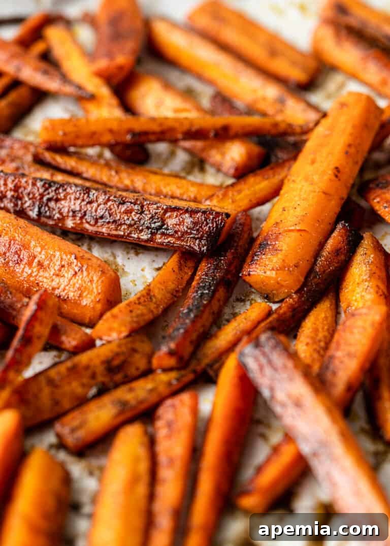 Process shot: a baking sheet filled with perfectly roasted Moroccan carrots, golden and caramelized, garnished and ready to be served.