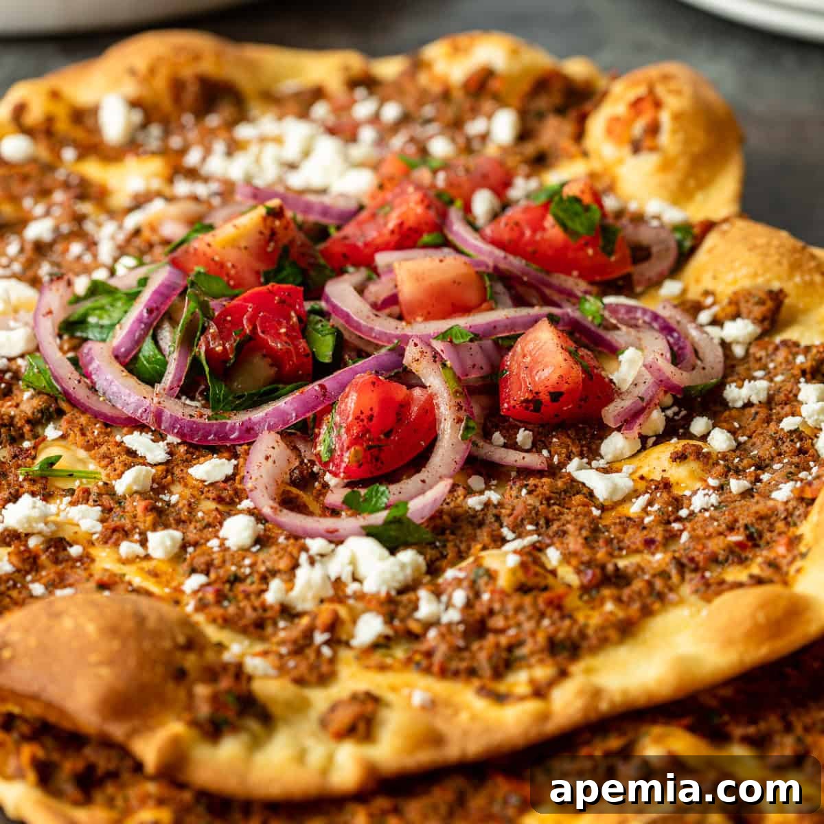 close up of ground lamb pizza topped with feta