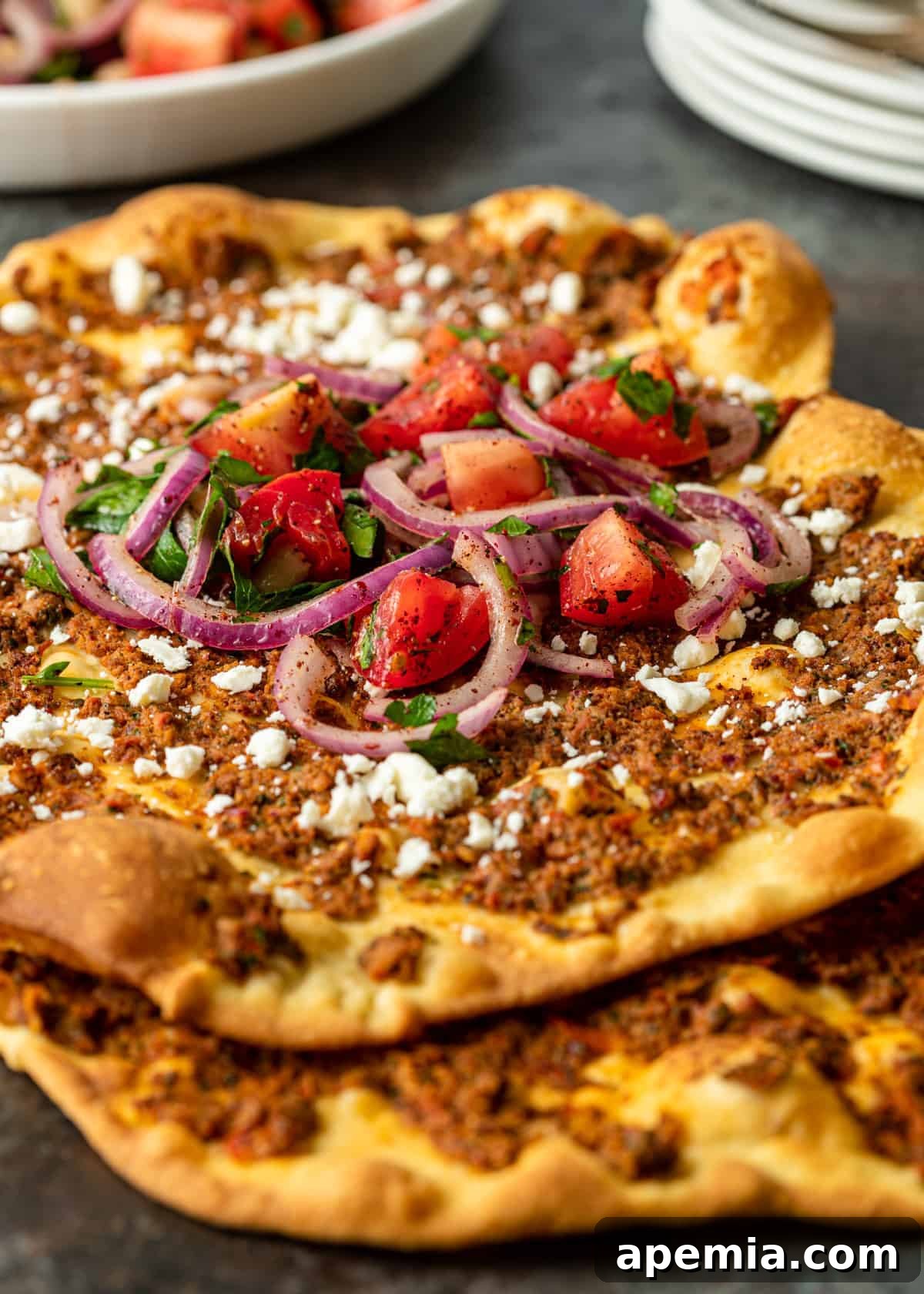 side view closeup: my lahmacun recipe topped with ground lamb and feta