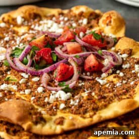 close up of ground lamb pizza topped with feta