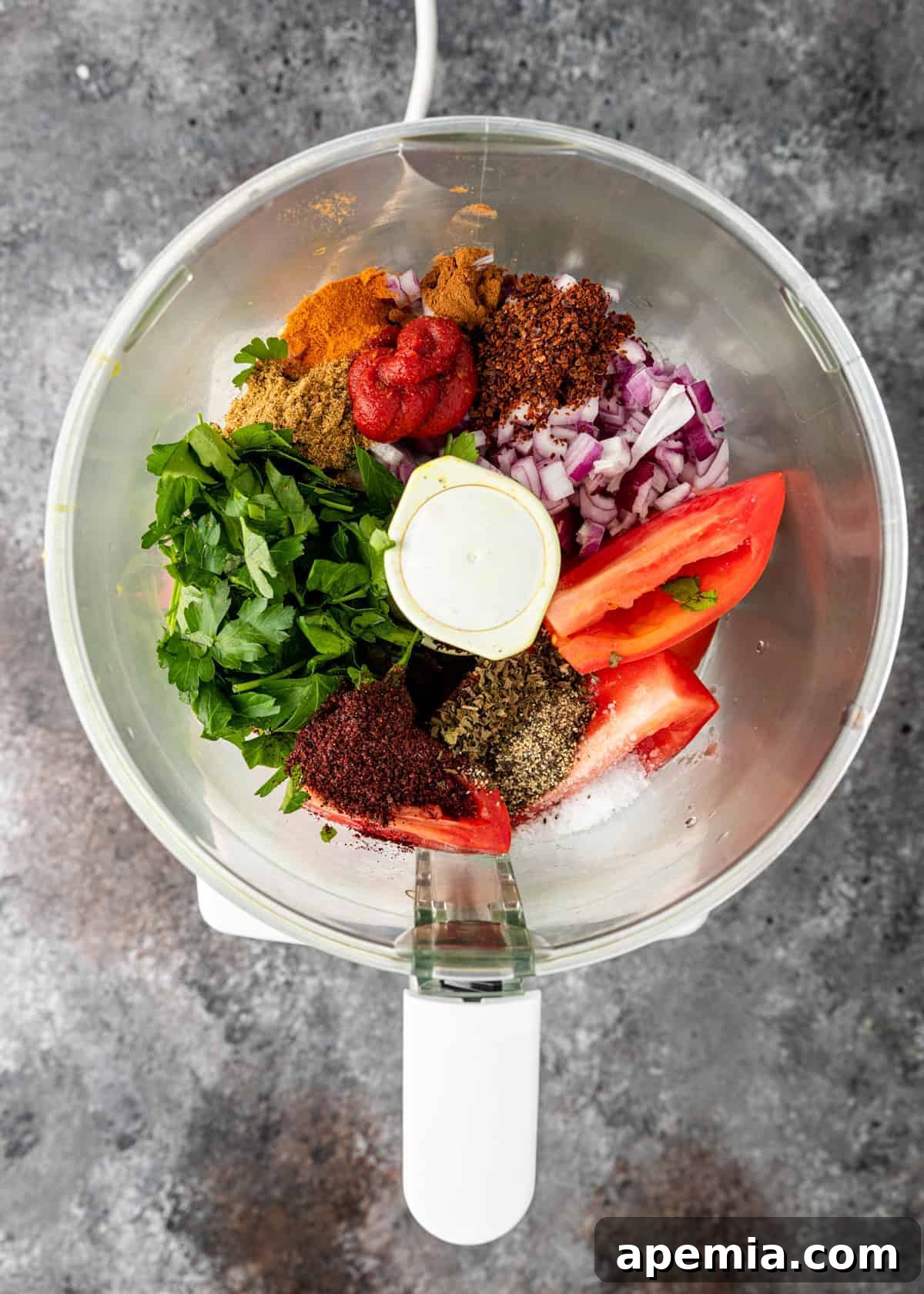 overhead process shot: fresh vegetables and spices in a food processor before processing