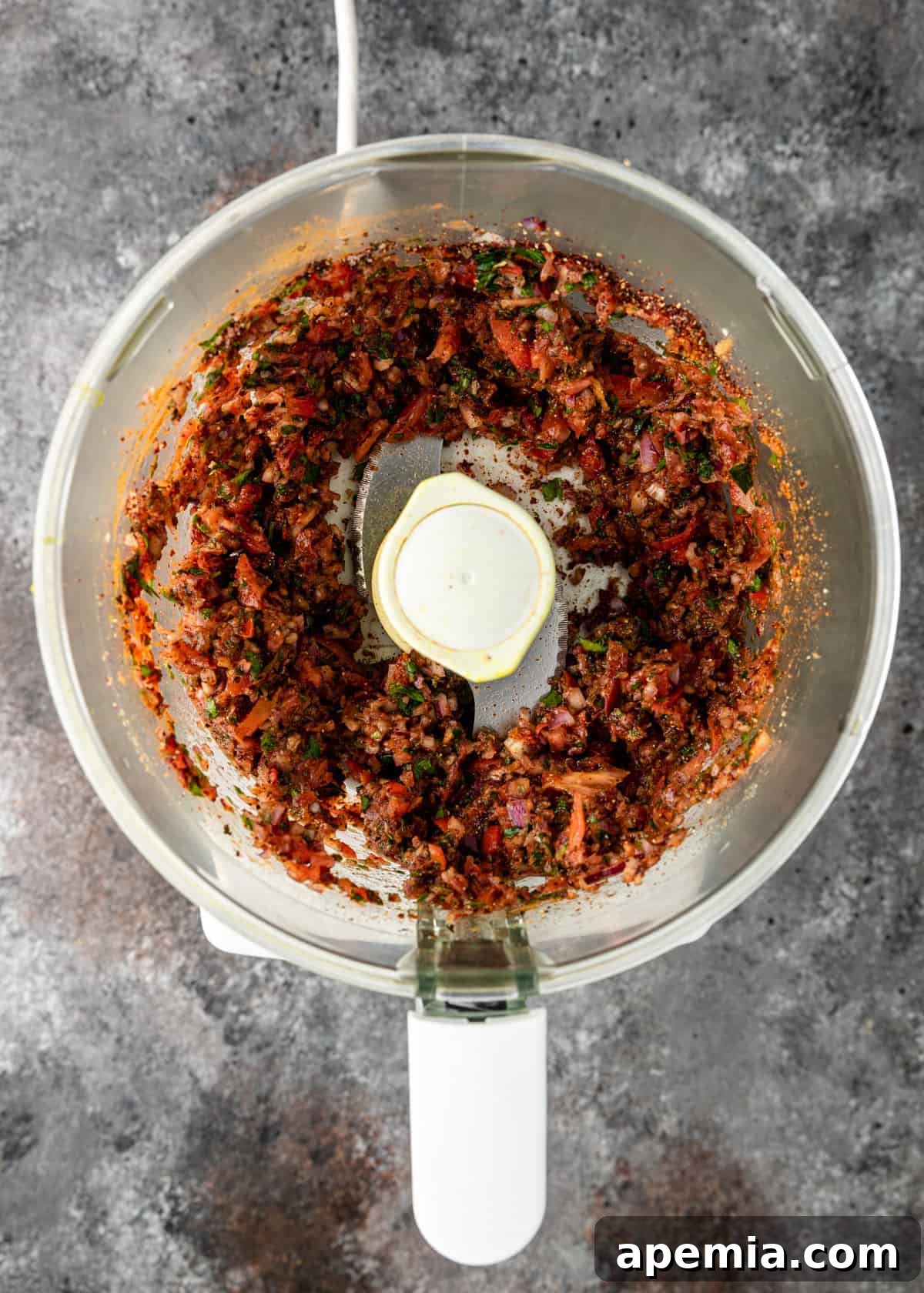 overhead process shot: puréed vegetables and spices in a food processor