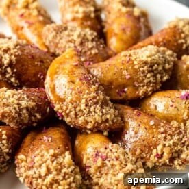 close up: fried stuffed pancakes dipped in crushed walnuts
