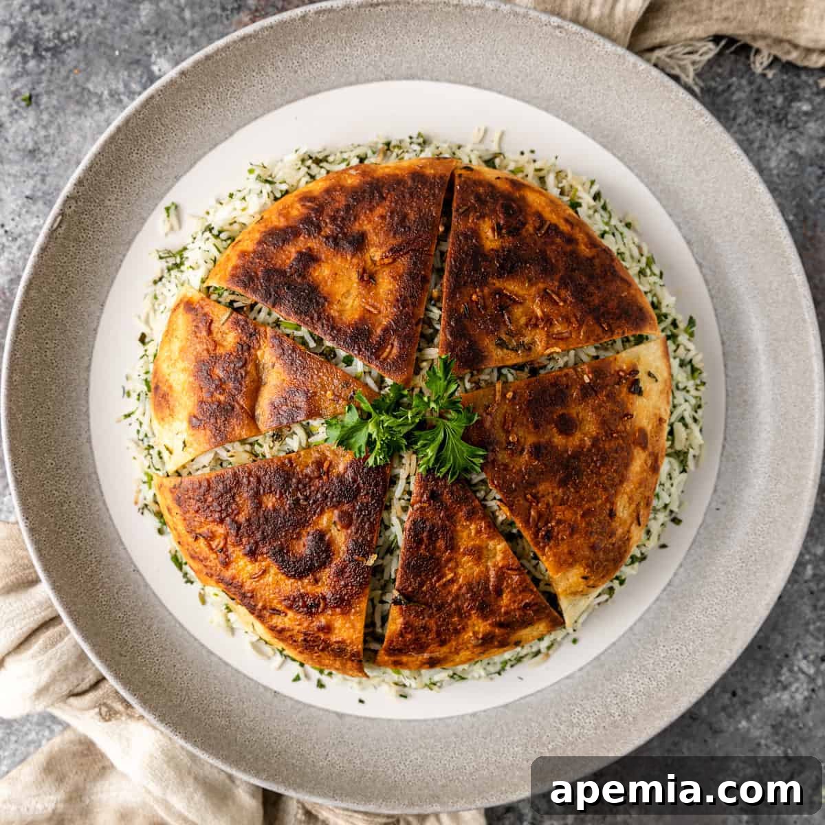 Overhead shot of Sabzi Polo with lavash Tahdig over herbed rice, garnished with fresh herbs.