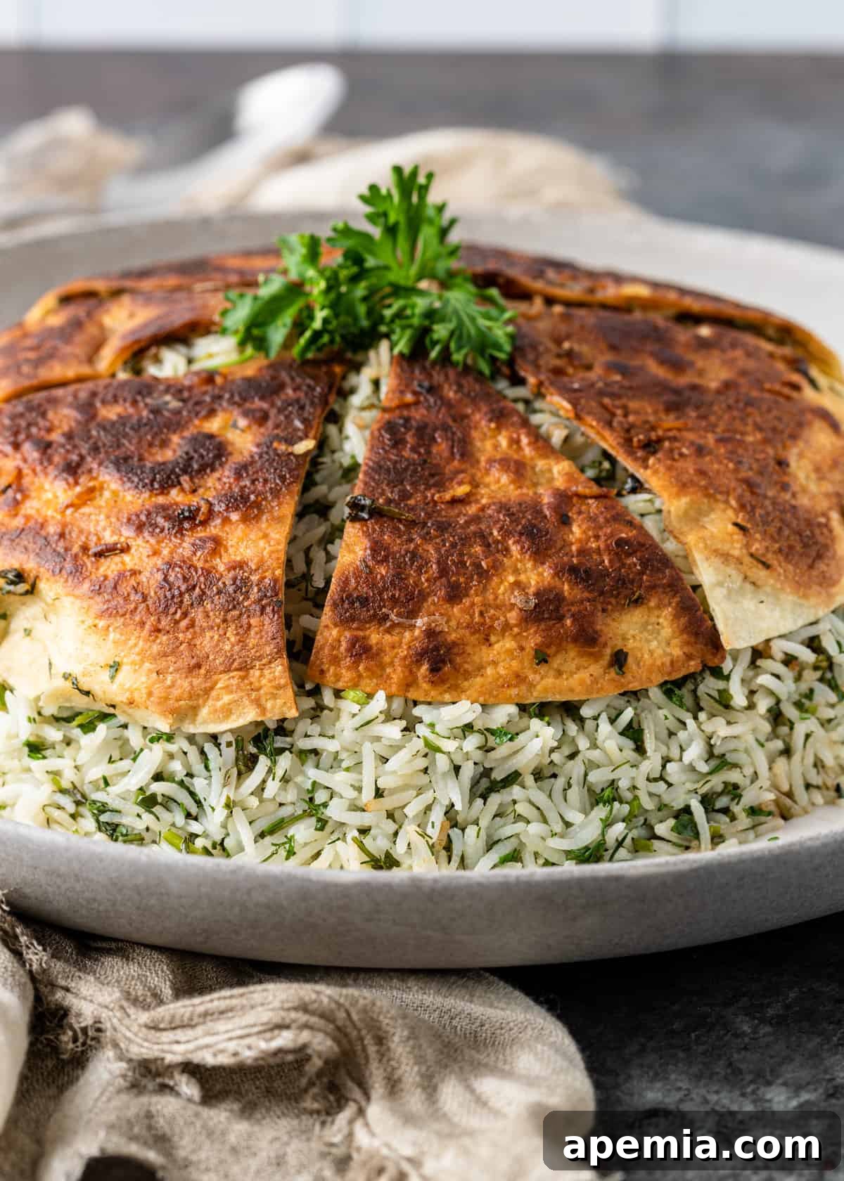 A pot of basmati rice with fresh herbs and a crispy flatbread Tahdig, steaming to perfection.