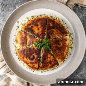 Overhead shot of Sabzi Polo with lavash Tahdig over herbed rice, garnished with fresh herbs.