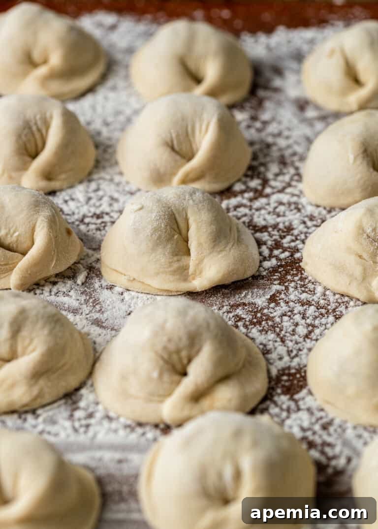 closeup: a pile of uncooked Lebanese meat dumplings, perfectly shaped and ready to be boiled
