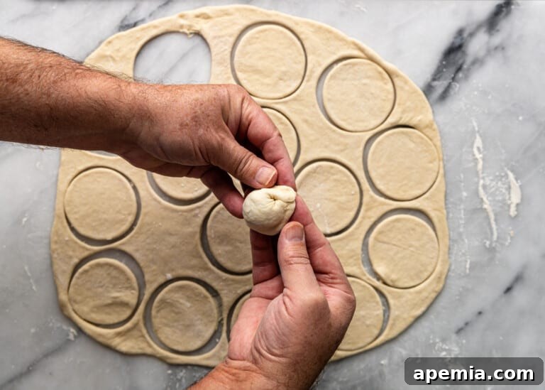 overhead: sealing meat dumpling before cooking, showing the finished tortellini shape