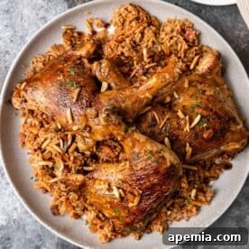 Overhead view of a plate of crispy, golden Kabsa, beautifully garnished.