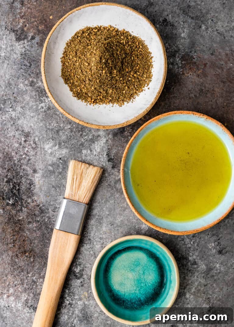 overhead: two small plates side by side with olive oil and zaatar