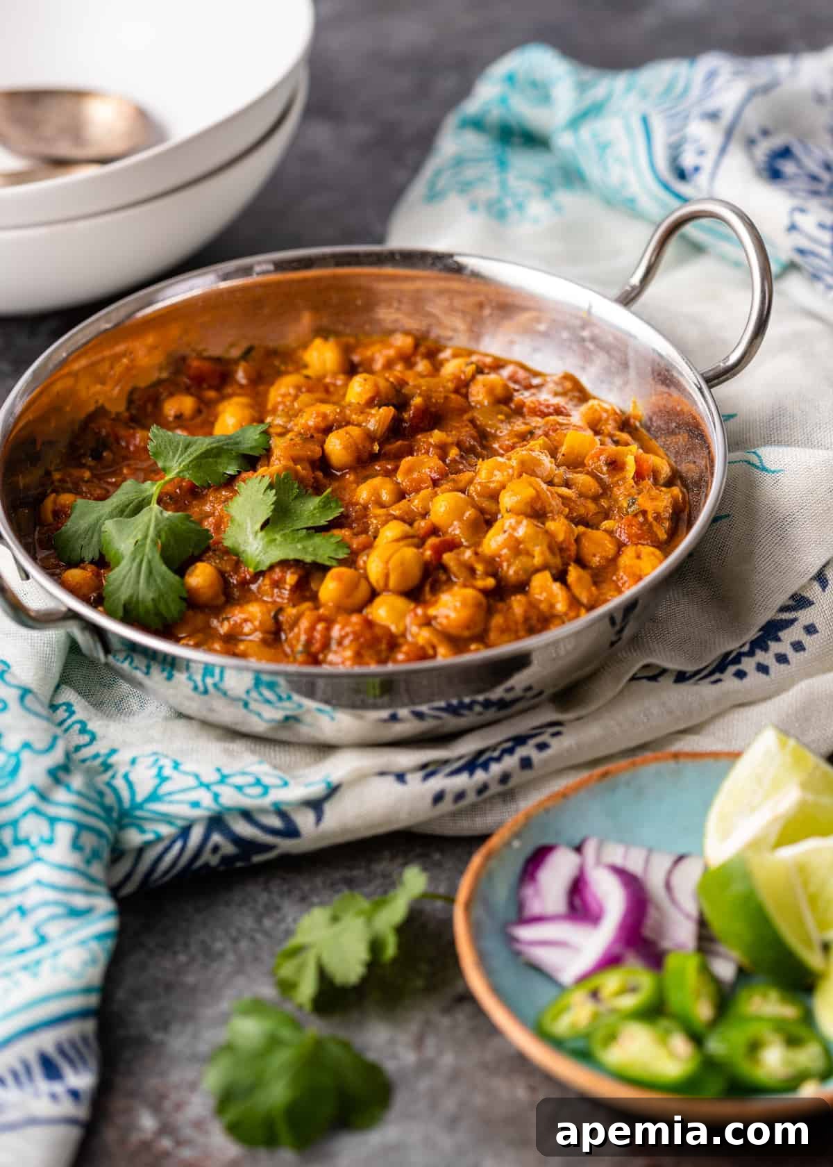 Punjabi Chole Masala served in a metal pan on a linen kitchen towel.
