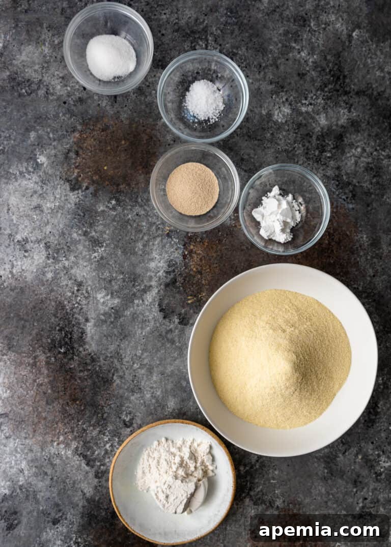 Overhead view of small bowls containing individual ingredients: semolina flour, active dry yeast, a pinch of salt, and a touch of sugar, ready to be combined for Moroccan pancake batter.