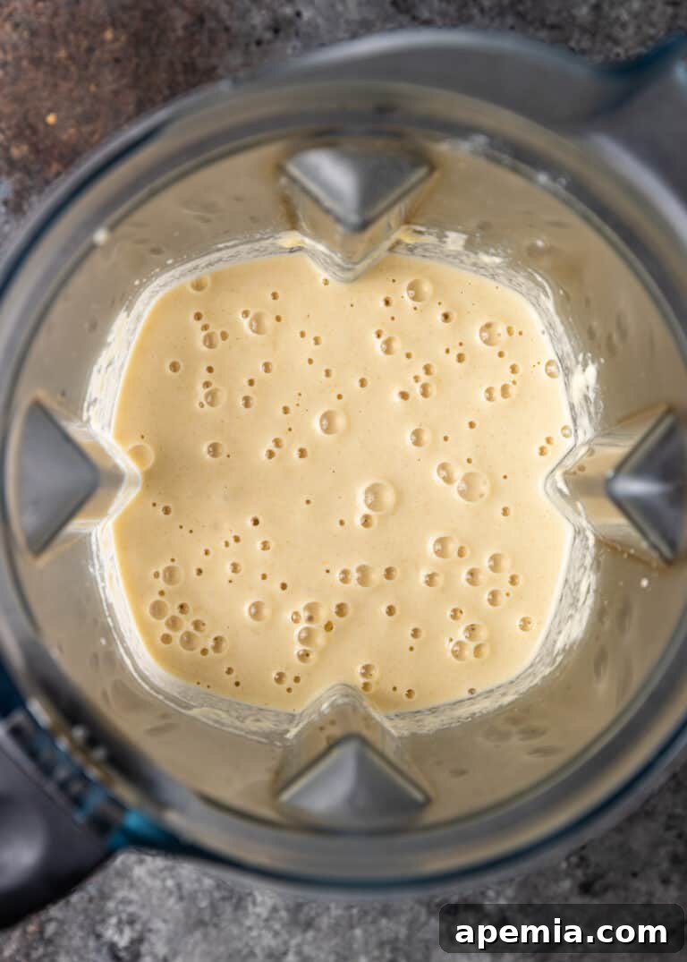 A blender jar filled with the smooth, pale yellow Baghrir batter, showing the ideal consistency before resting and cooking.