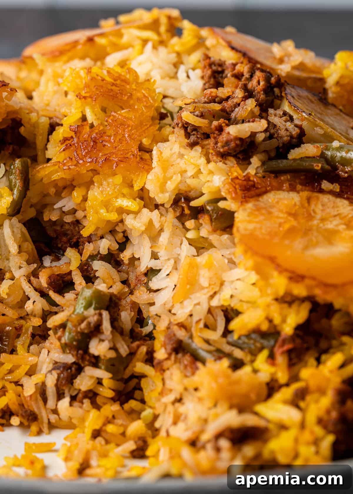 closeup: lubia persian casserole with rice, potatoes, green beans and ground meat