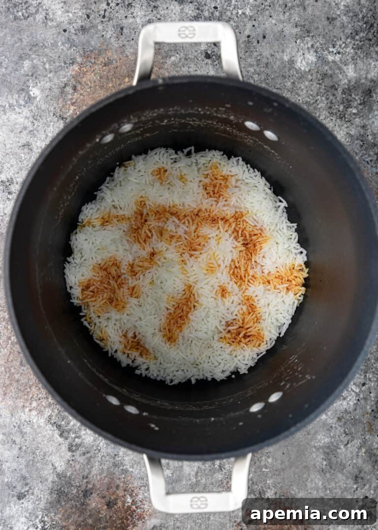 overhead process shot: cooking rice with cinnamon in large pot