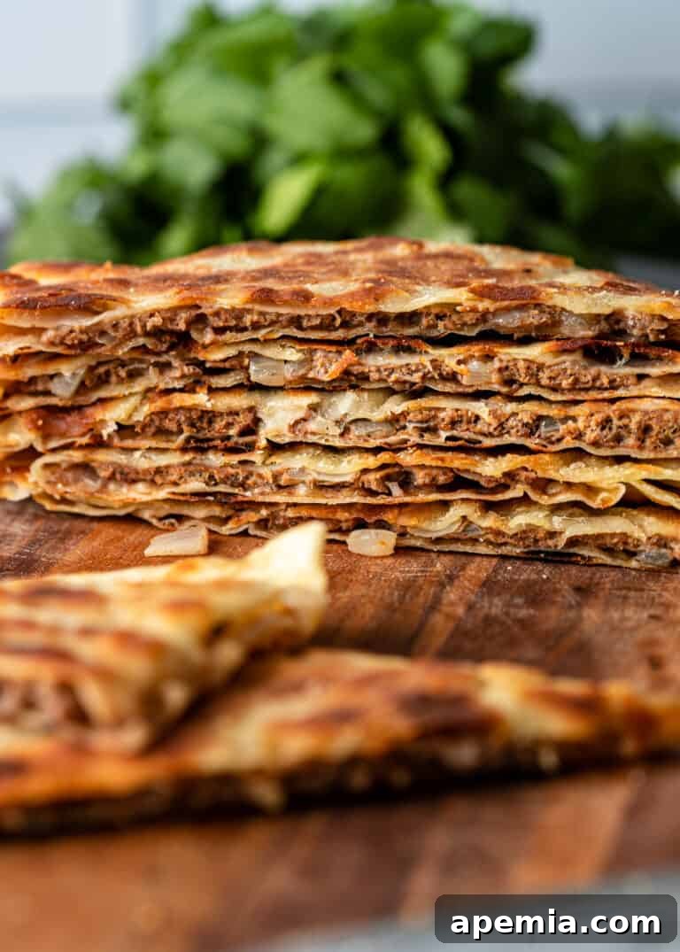 Side view of a stack of thin Turkish stuffed flatbreads (Gozleme).