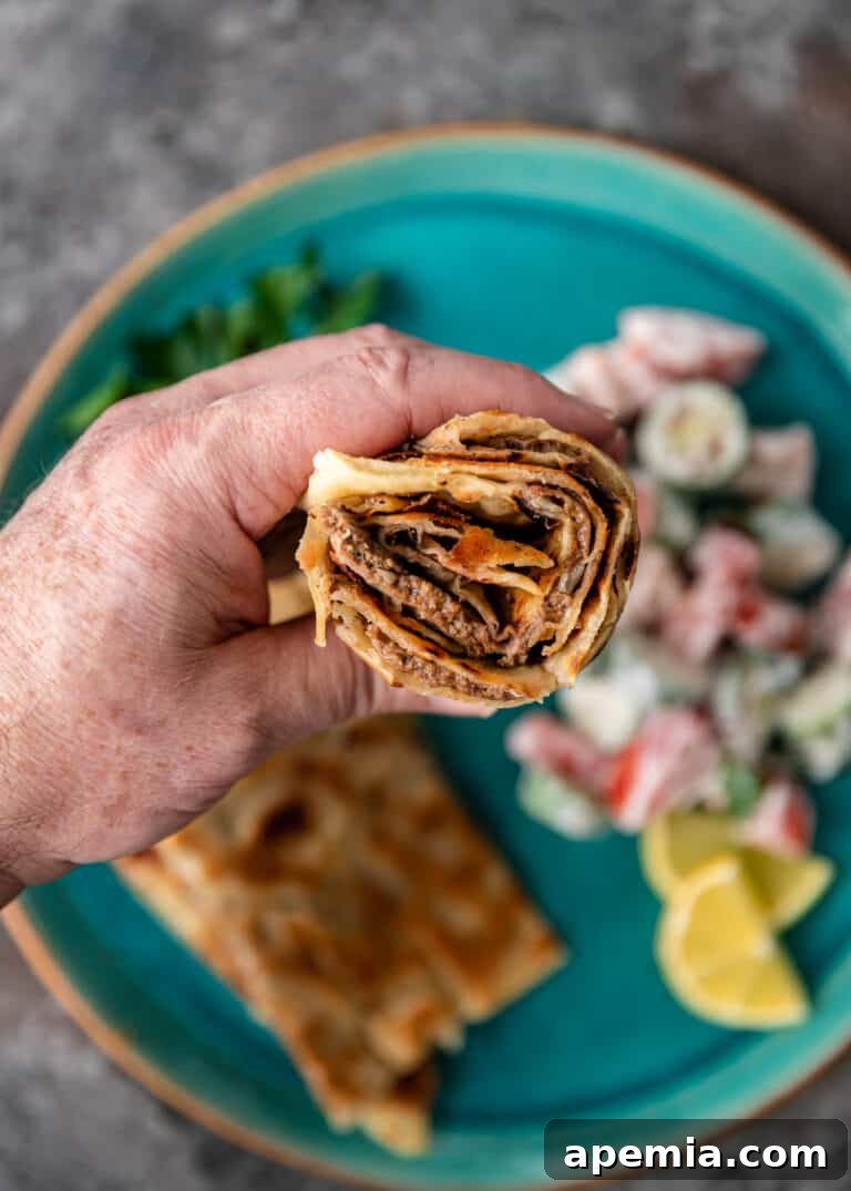 Overhead closeup of Gozleme fillings rolled inside the flatbread, showing the texture and ingredients.