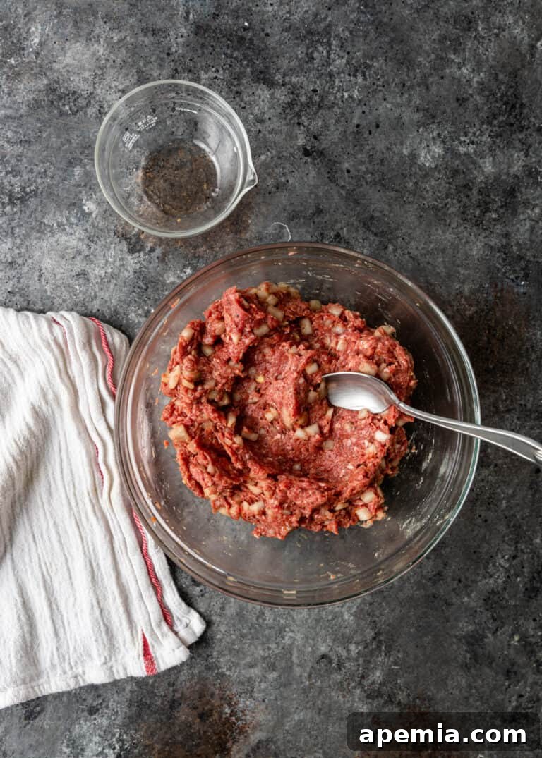Overhead process shot: Raw ground meat filling prepared in a glass mixing bowl for the Gozleme recipe.