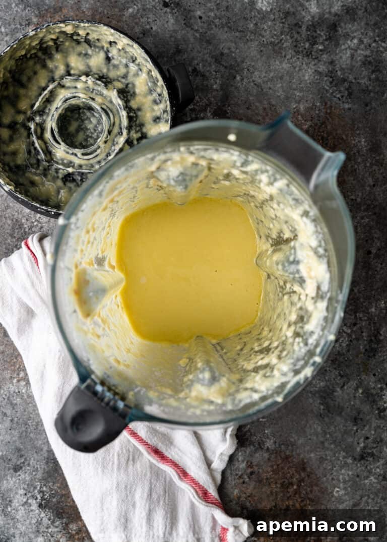 overhead: blender with puree of olive oil, almonds, garlic, lemon juice and water for a Skordalia recipe