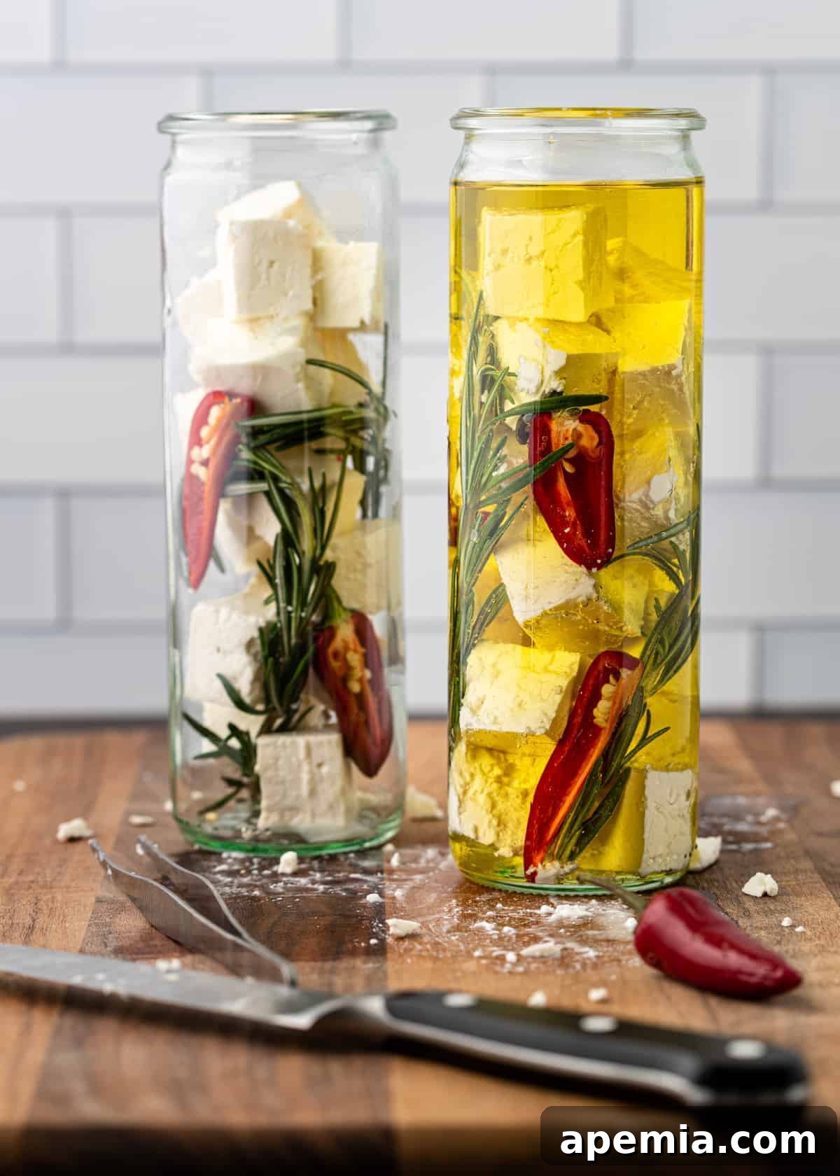 image showing how to layer feta, herbs, and chiles in olive oil in a jar