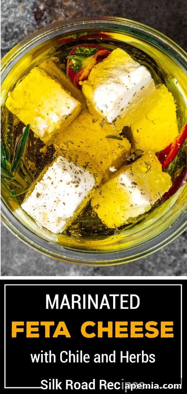 titled image (and shown in glass jar): Marinated Feta Cheese with Chile and Herbs - Silk Road Recipes