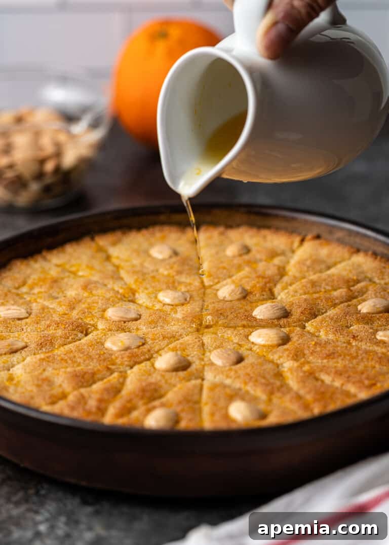 Egyptian Basbousa Golden Semolina Bliss 12 Side view showing the final stages of syrup absorption, as the golden Basbousa cake is covered in a glistening layer of orange sugar glaze.