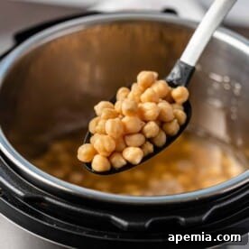 Instant Pot chickpeas on slotted spoon